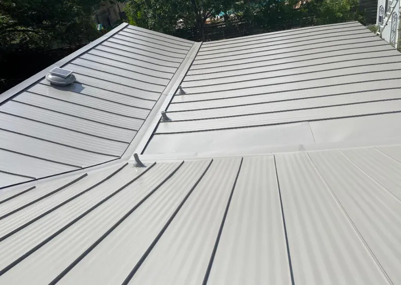 Solar attic fan installed on a metal roof for Roof Ventilation in West Park