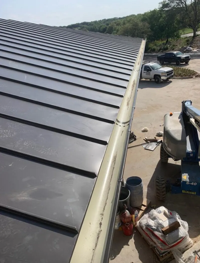 Standing seam panel and gutter detail on a metal roofing jobsite in West Park